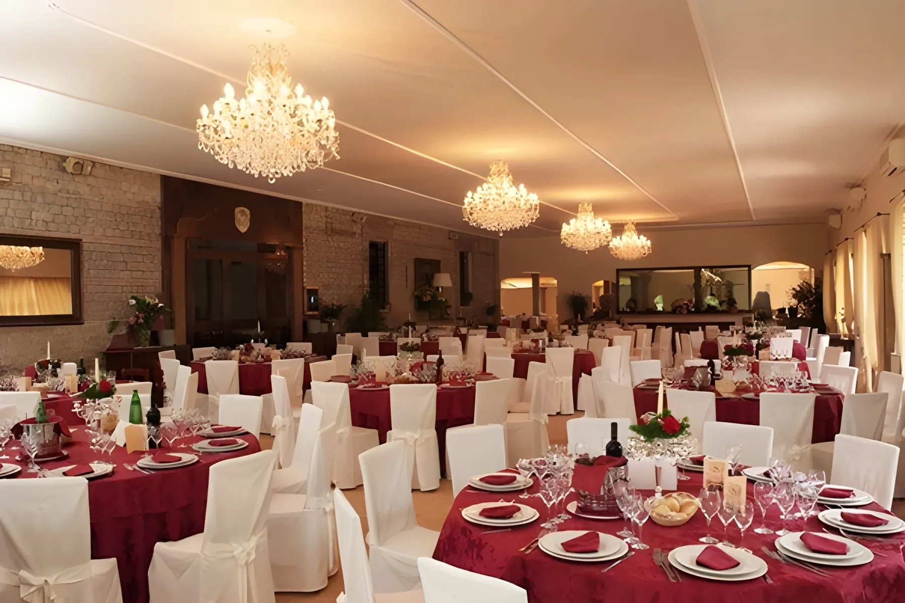 Sala di Villa dei Principi allestita con tavoli rossi e lampadari accesi